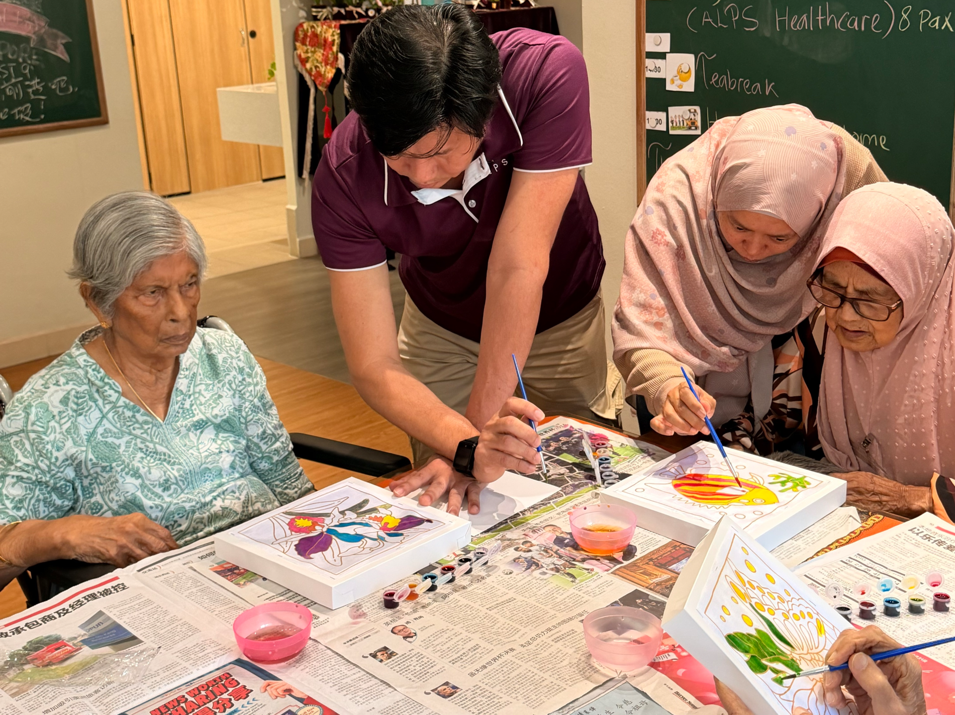 Image of ALPS volunteers at HCA Oasis @ Woodlands Day Hospice, interacting with patients